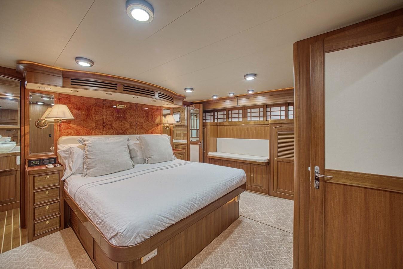 a bedroom with a bed and a closet aboard RODE RUNNER II Yacht for Sale