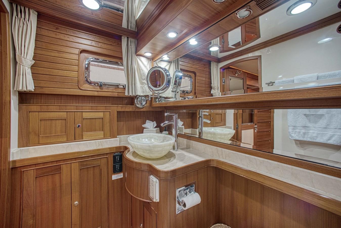 a bathroom with a sink and cabinets aboard RODE RUNNER II Yacht for Sale