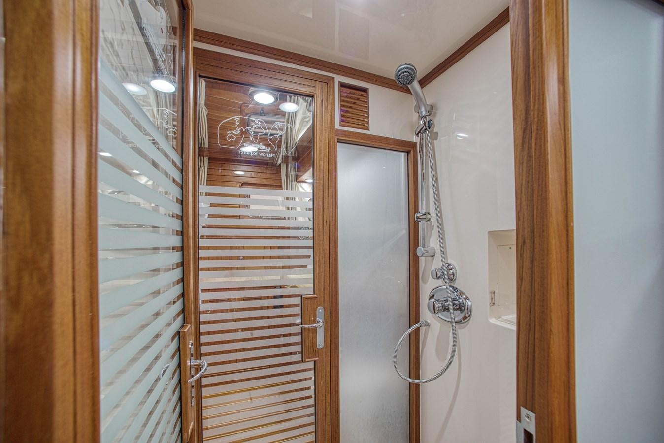a room with a door and a mirror aboard RODE RUNNER II Yacht for Sale