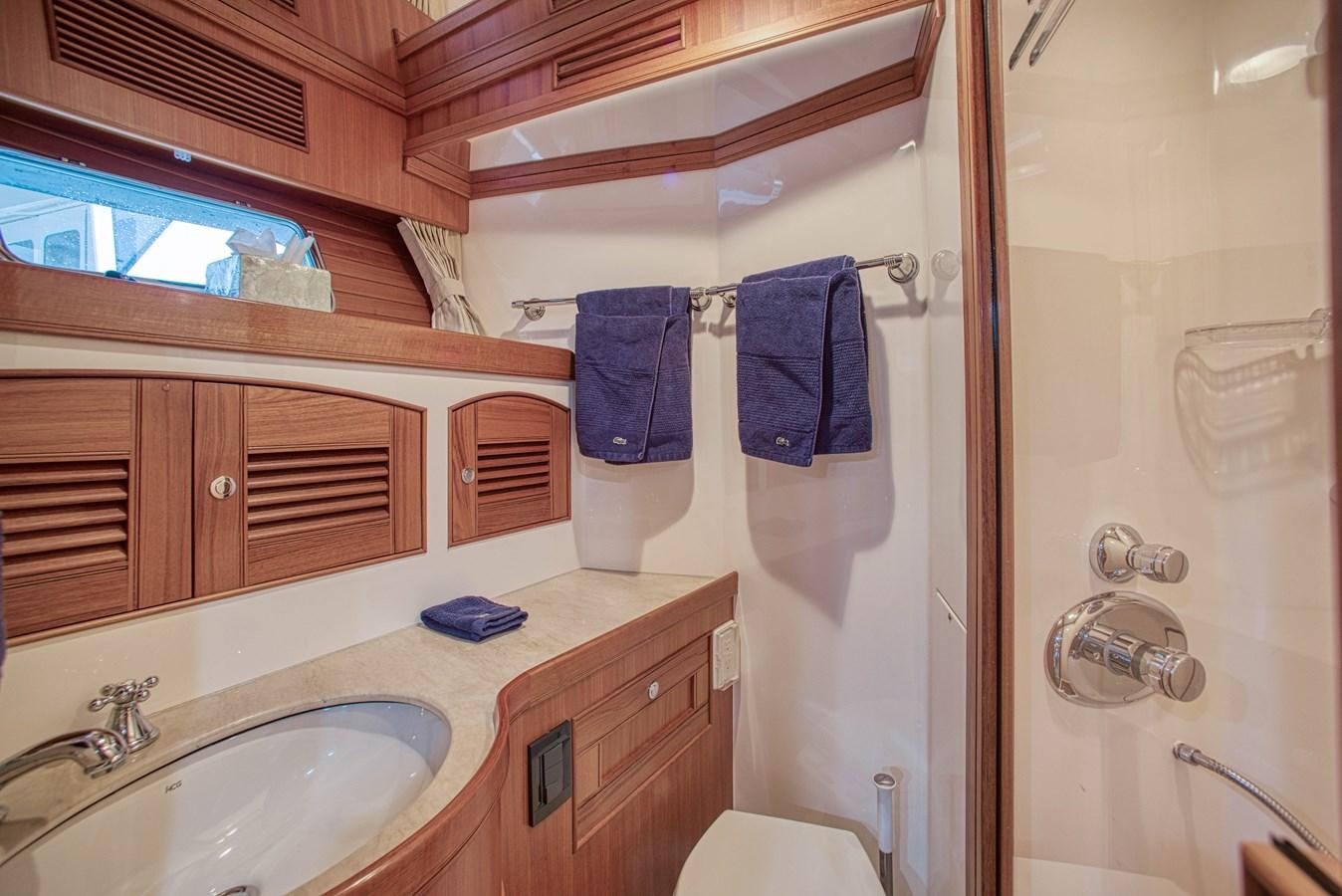 a bathroom with a sink and a mirror aboard RODE RUNNER II Yacht for Sale