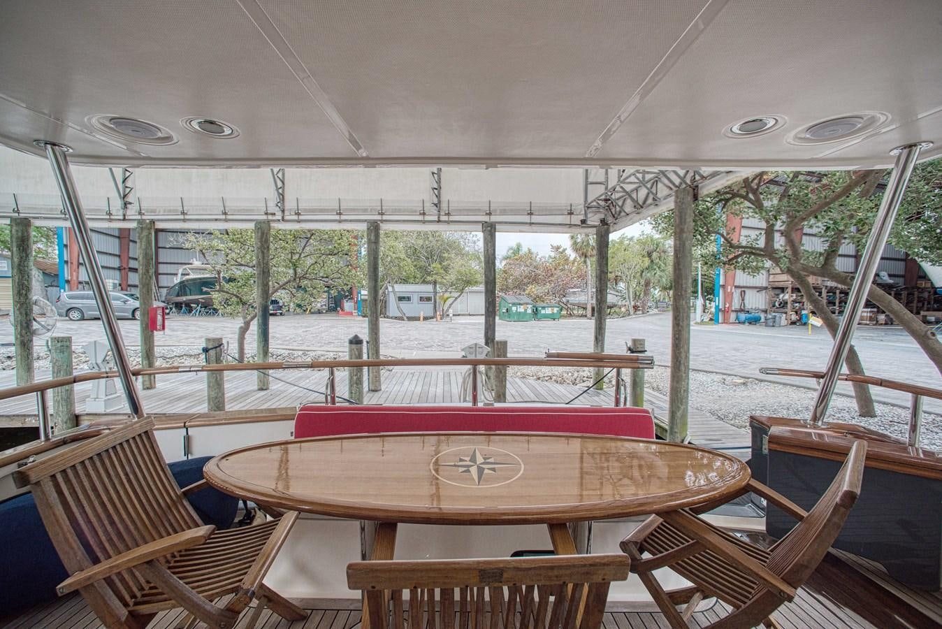 a table on a porch aboard RODE RUNNER II Yacht for Sale