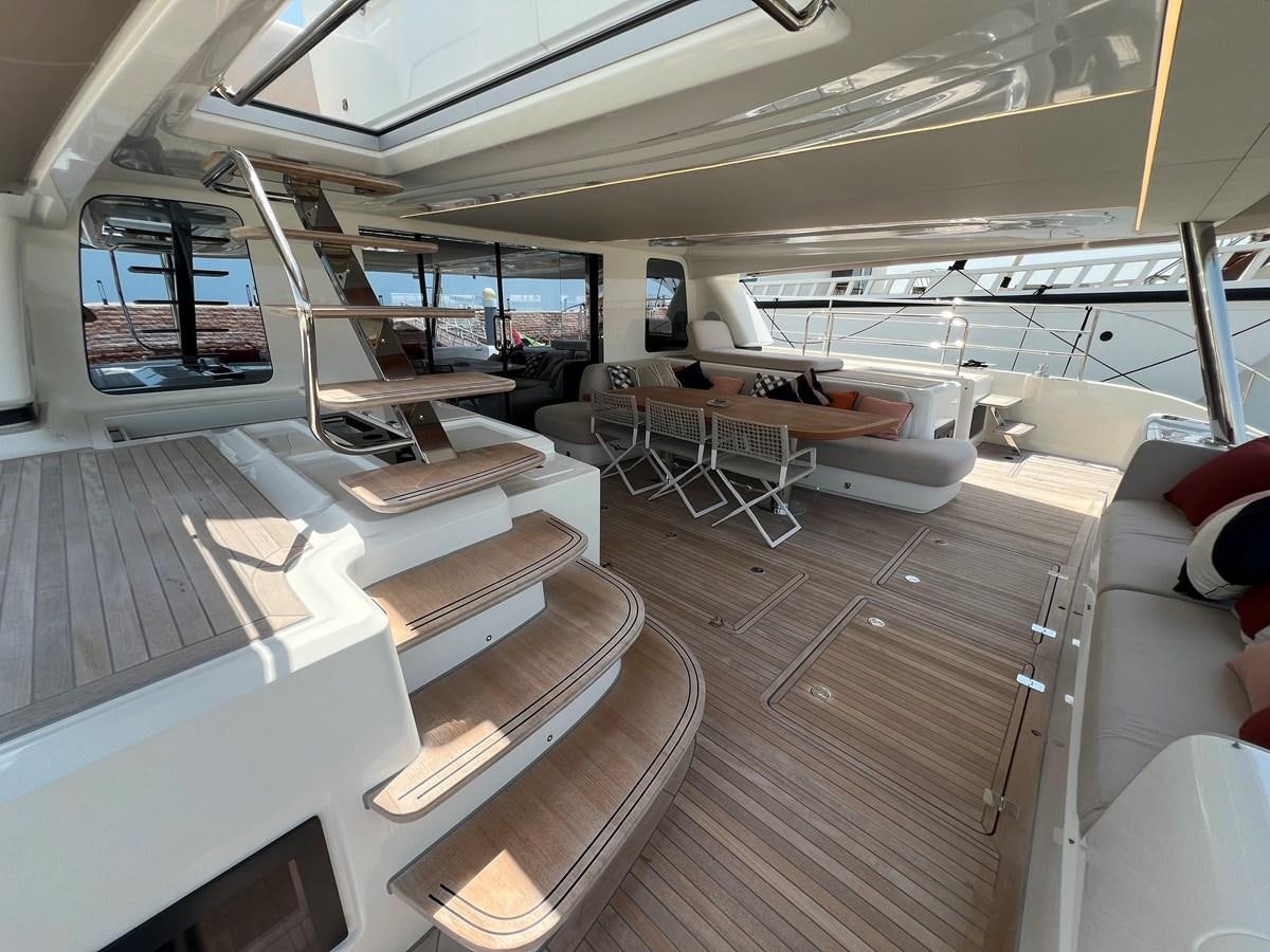 a room with tables and chairs aboard 2023 LAGOON 67 Yacht for Sale
