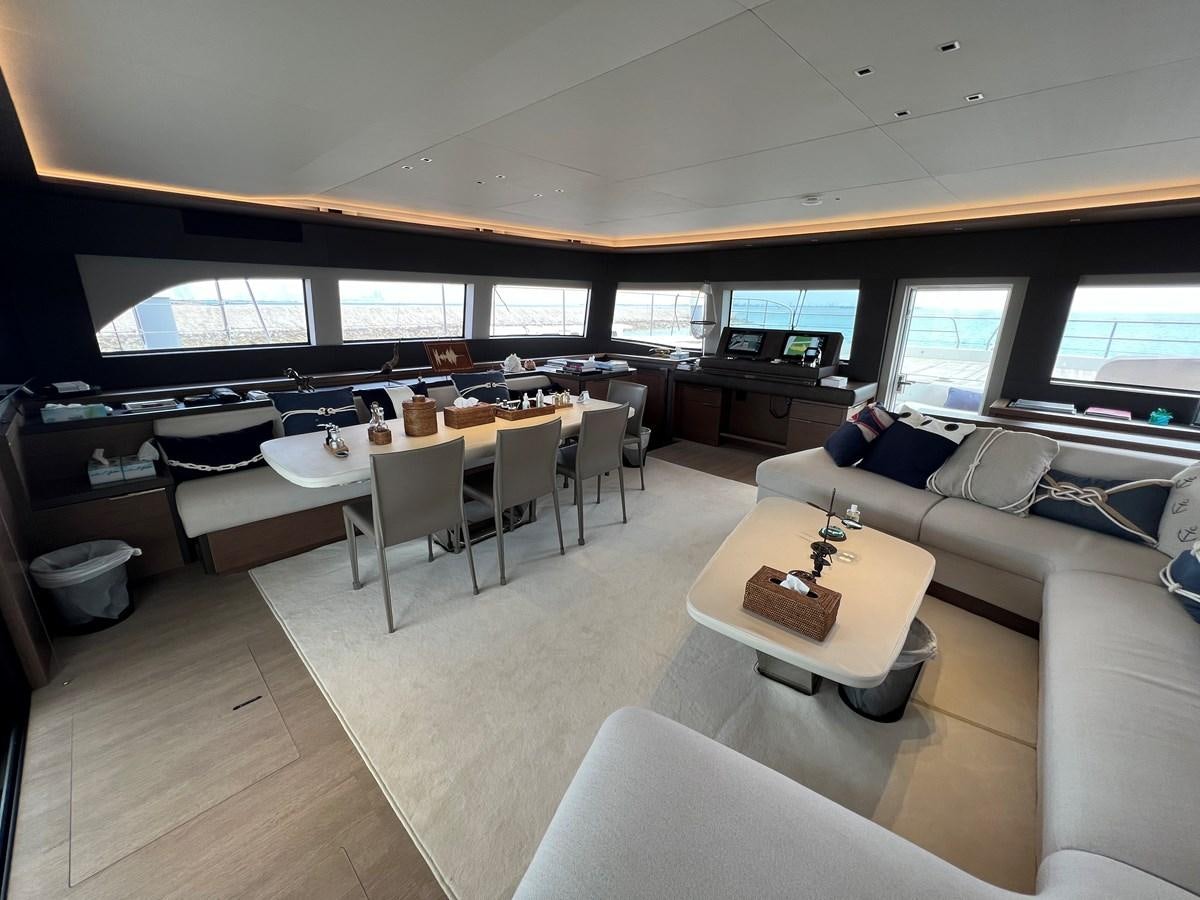 a living room with a couch and a table aboard 2023 LAGOON 67 Yacht for Sale