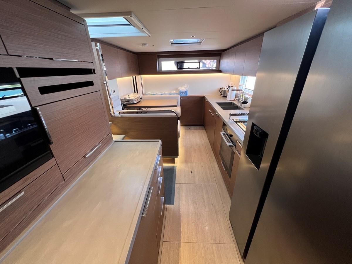 a kitchen with a large refrigerator aboard 2023 LAGOON 67 Yacht for Sale