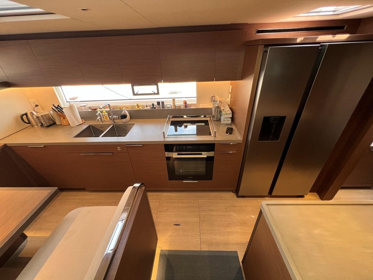 a kitchen with a sink and cabinets aboard 2023 LAGOON 67 Yacht for Sale