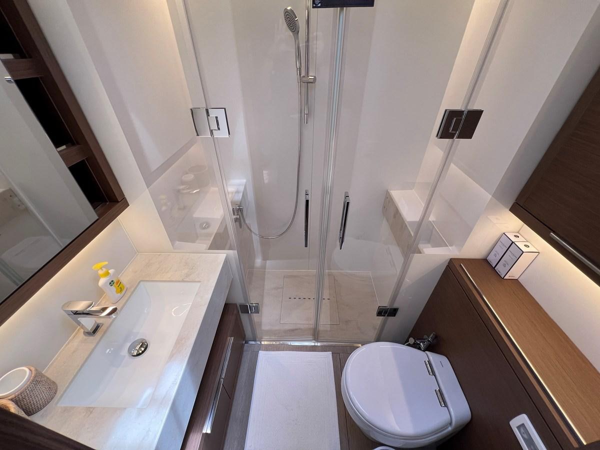 a bathroom with a shower and sink aboard 2023 LAGOON 67 Yacht for Sale