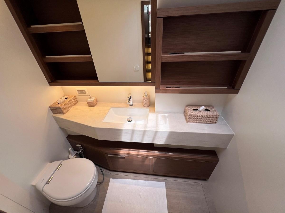 a bathroom with a sink and a toilet aboard 2023 LAGOON 67 Yacht for Sale