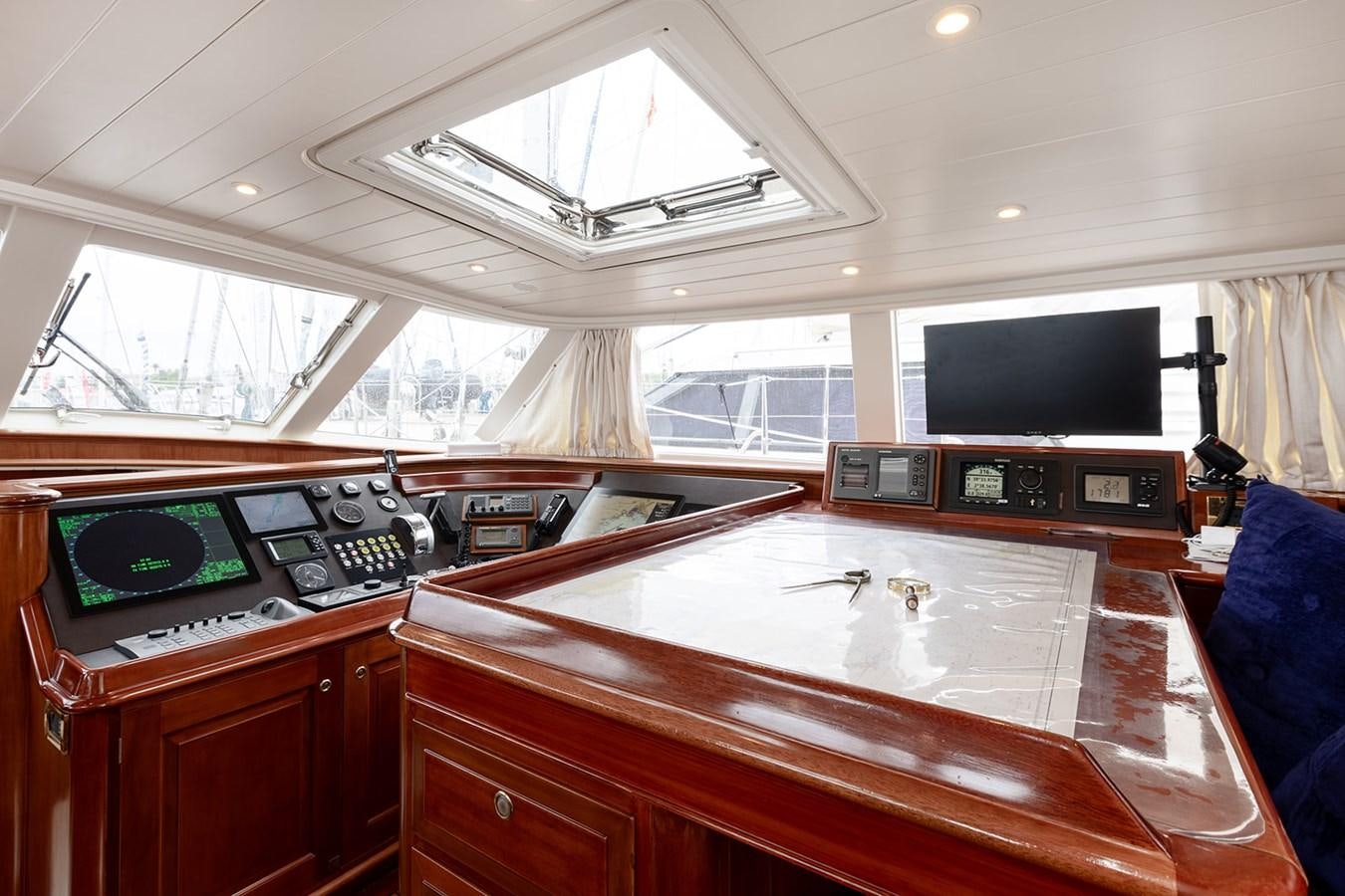 a room with a table and tv aboard IRELANDA Yacht for Sale
