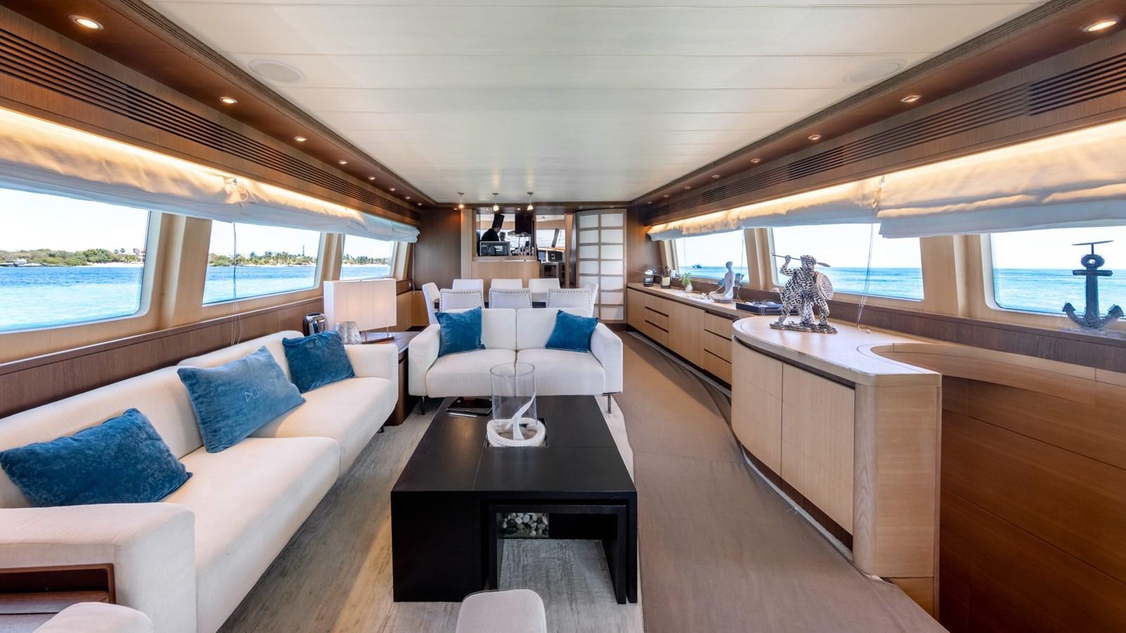 a living room with a couch and a table aboard DOMINIC  2008 MAIORA 27M @ PUERTO AVENTURAS Yacht for Sale