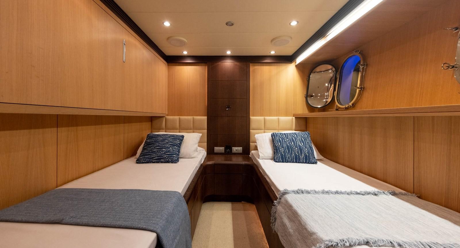 a room with beds and a mirror aboard DOMINIC  2008 MAIORA 27M @ PUERTO AVENTURAS Yacht for Sale