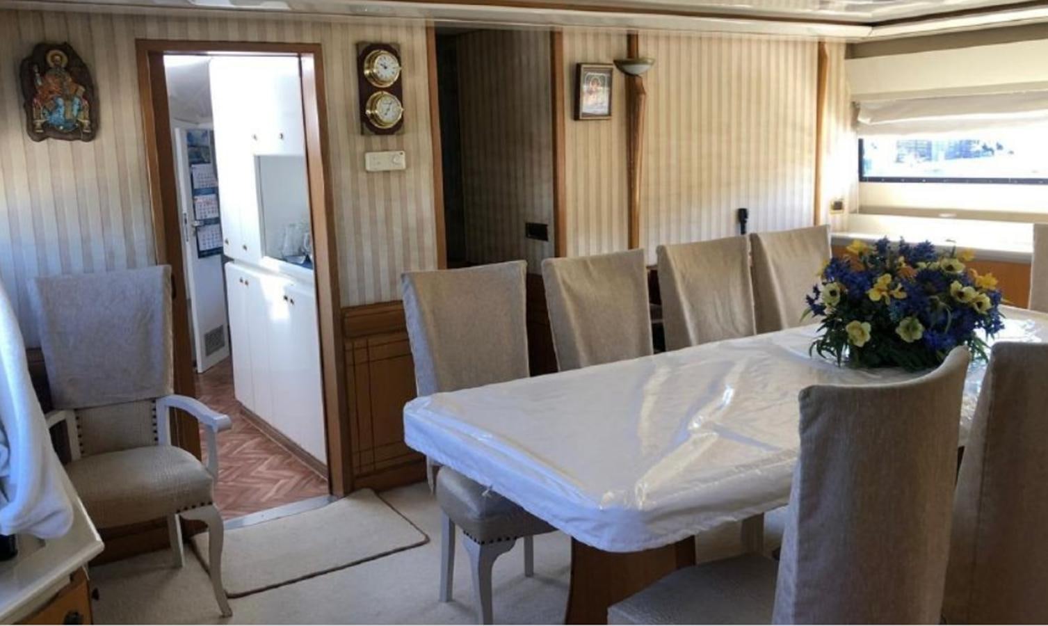 a dining table with chairs aboard ORYX Yacht for Sale