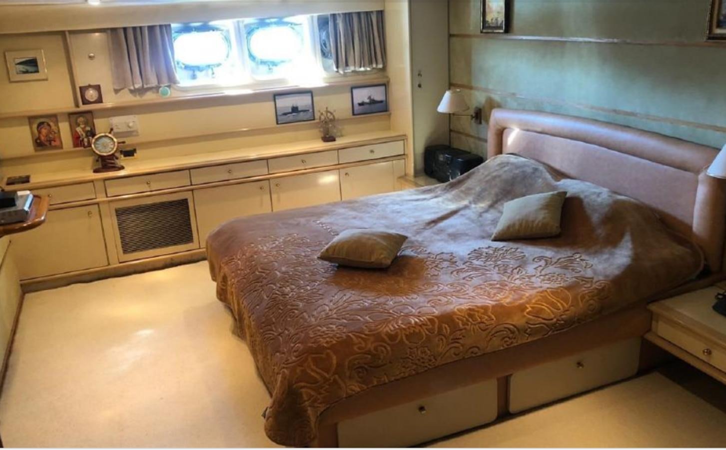 a bedroom with a bed and a desk aboard ORYX Yacht for Sale