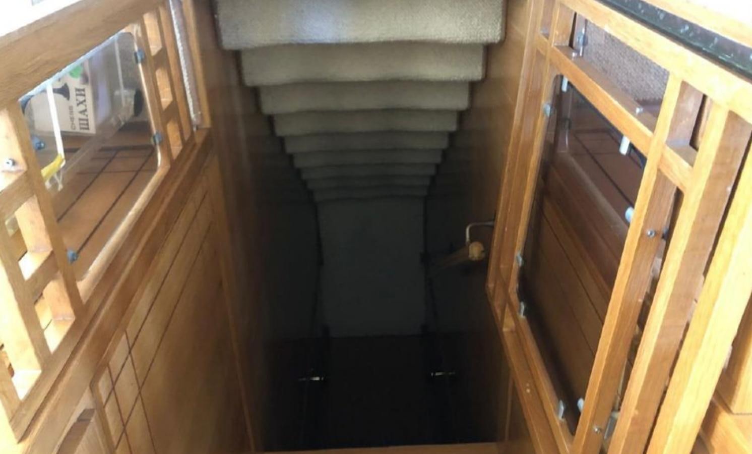 a wooden staircase with a railing aboard ORYX Yacht for Sale
