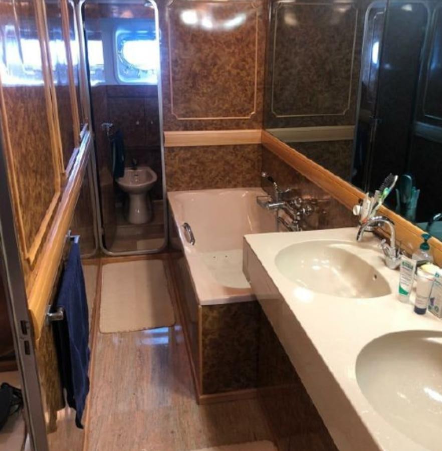 a bathroom with a tub sink and sink aboard ORYX Yacht for Sale