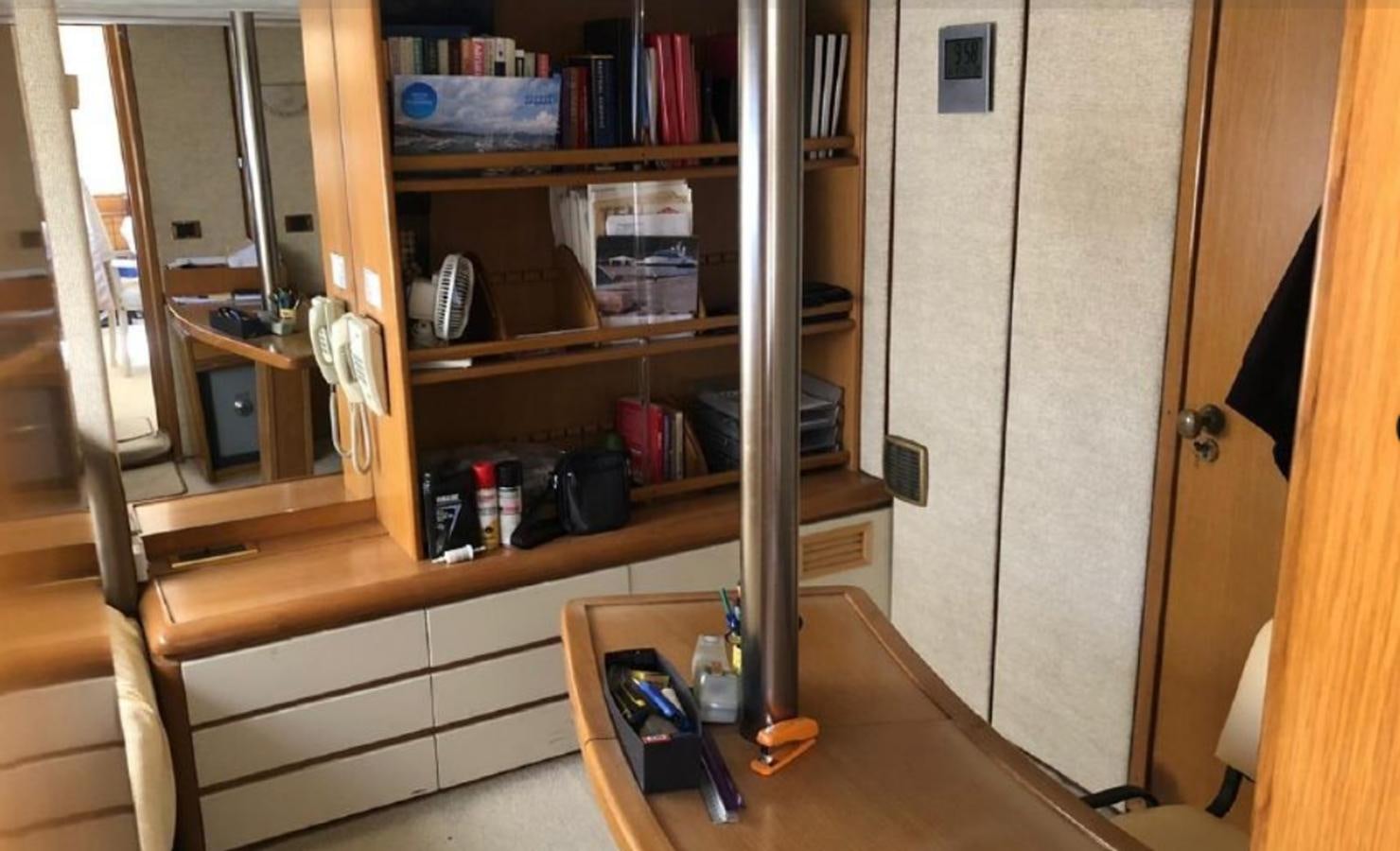 a shelf with books and a desk aboard ORYX Yacht for Sale