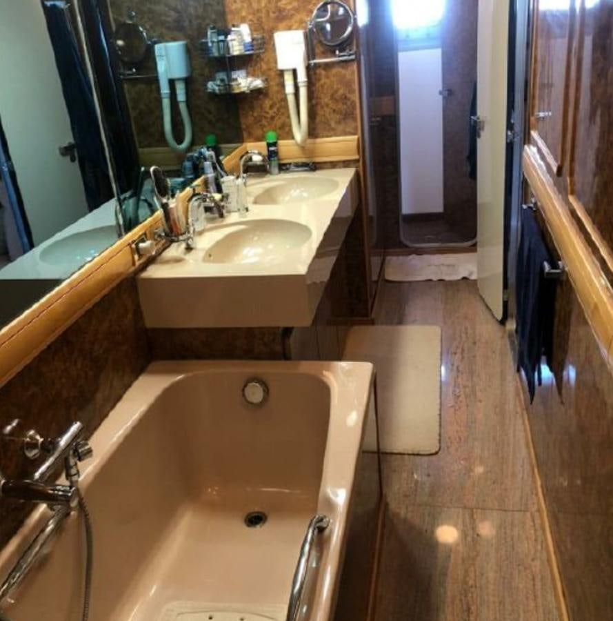 a bathroom with a tub sink and a sink aboard ORYX Yacht for Sale