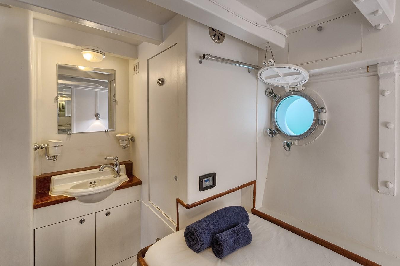 a bathroom with a sink and a mirror aboard PHILMARBE - ORTIGOZA COFADIC Yacht for Sale