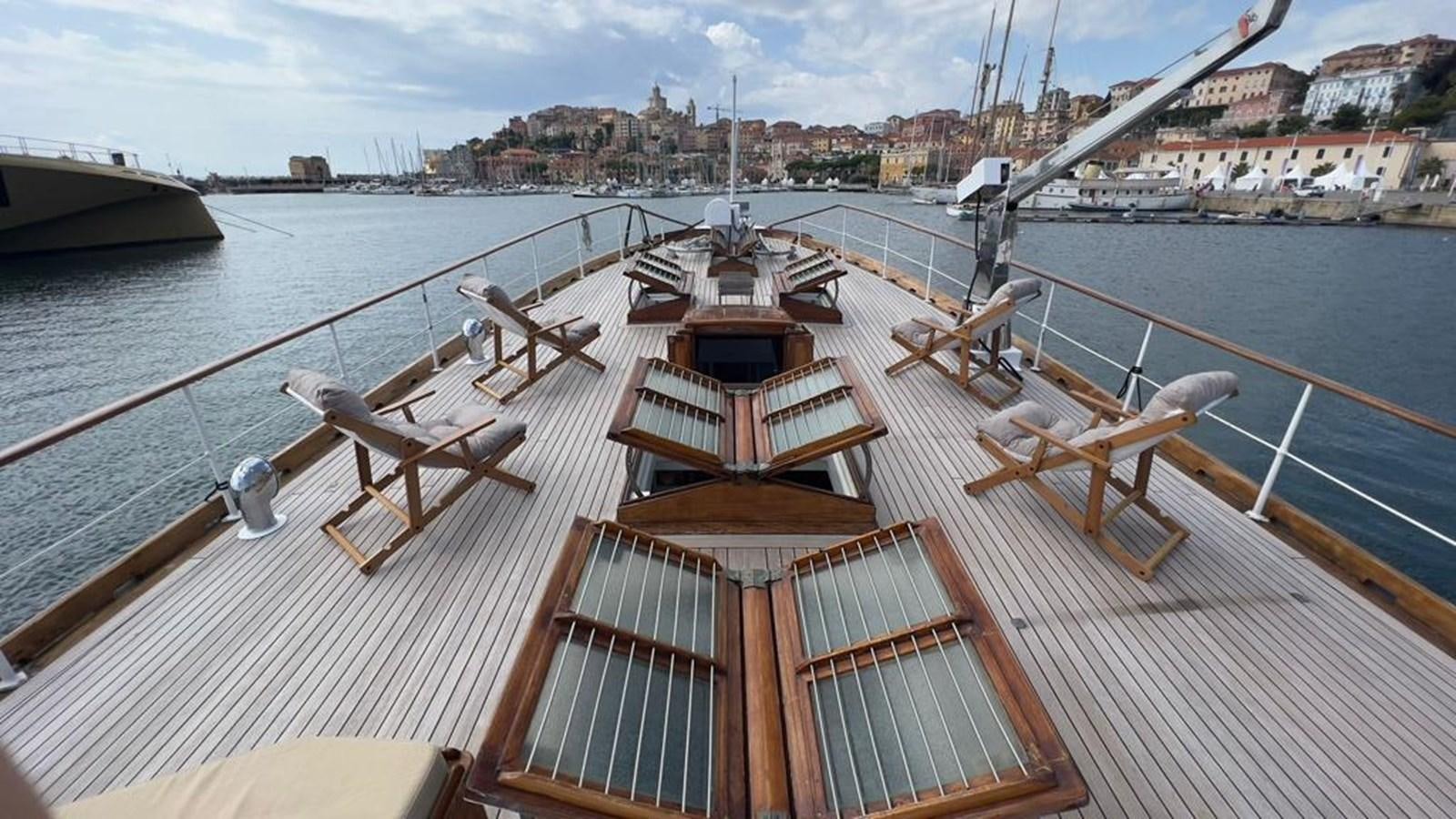 a deck with a view of a city and boats on it aboard PHILMARBE - ORTIGOZA COFADIC Yacht for Sale