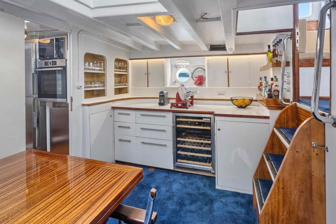 a kitchen with a table and a stove aboard PHILMARBE - ORTIGOZA COFADIC Yacht for Sale