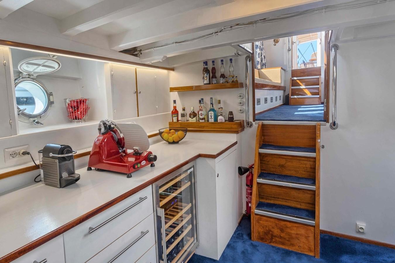 a kitchen with a red chair aboard PHILMARBE - ORTIGOZA COFADIC Yacht for Sale