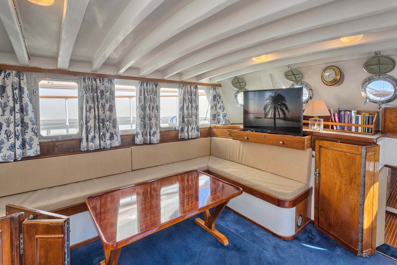 a room with a table and a couch aboard PHILMARBE - ORTIGOZA COFADIC Yacht for Sale