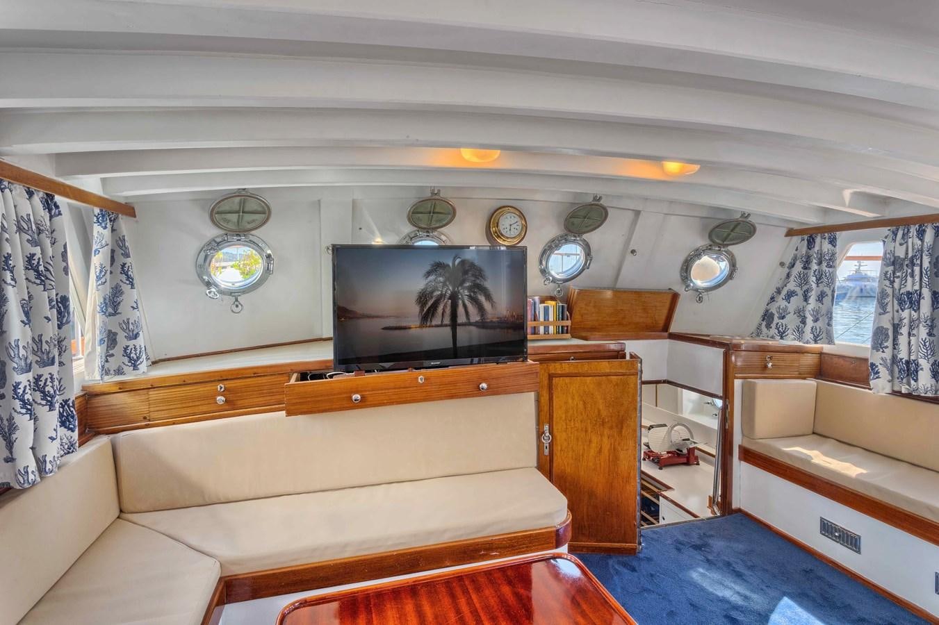 a living room with a couch and a tv aboard PHILMARBE - ORTIGOZA COFADIC Yacht for Sale