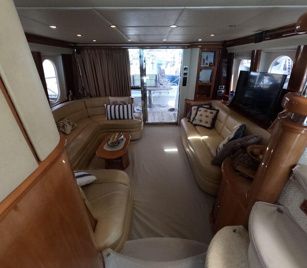 a living room with a large window aboard PYRAMID Yacht for Sale