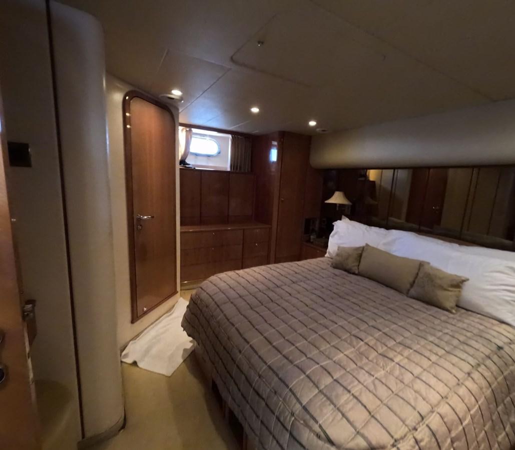 a bed with a white sheet aboard PYRAMID Yacht for Sale