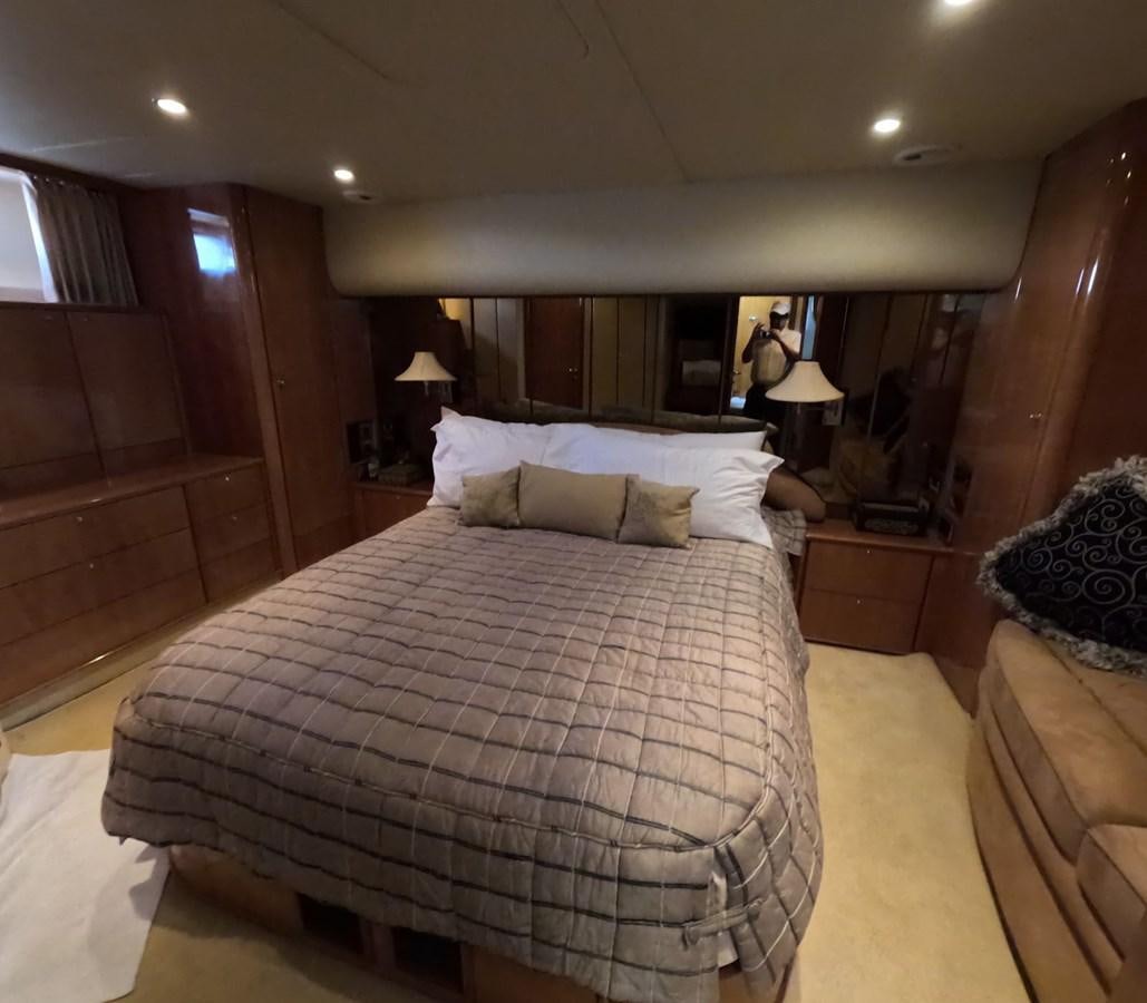 a bedroom with a bed and a wood wall aboard PYRAMID Yacht for Sale