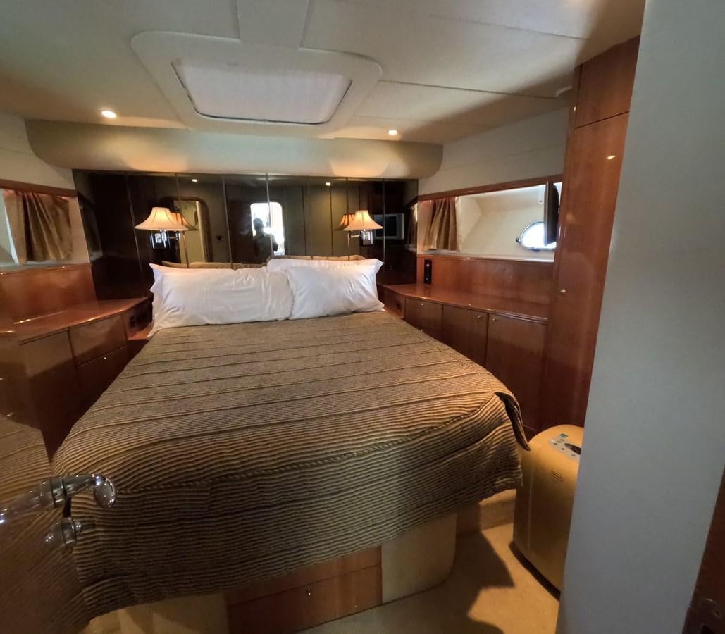 a bed with a large headboard aboard PYRAMID Yacht for Sale