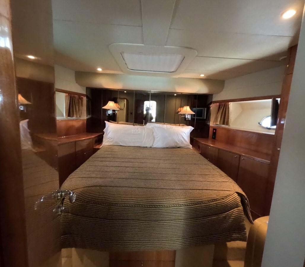 a bed with a large mirror above it aboard PYRAMID Yacht for Sale
