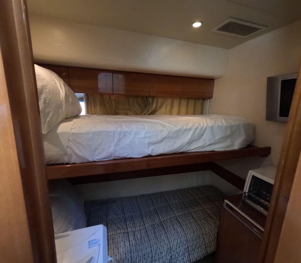 a bed with a white sheet aboard PYRAMID Yacht for Sale