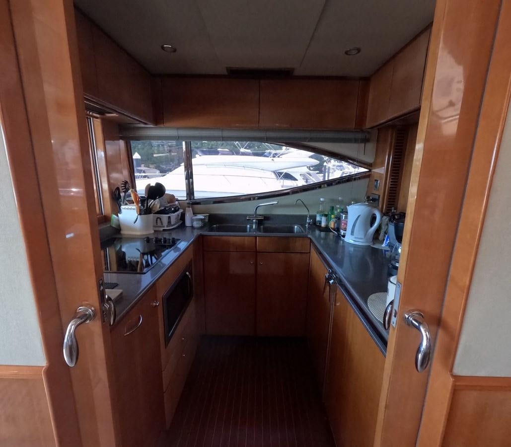 a kitchen with a large window aboard PYRAMID Yacht for Sale