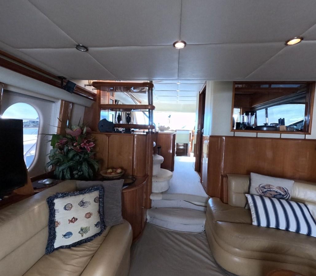a living room with a couch and a television aboard PYRAMID Yacht for Sale