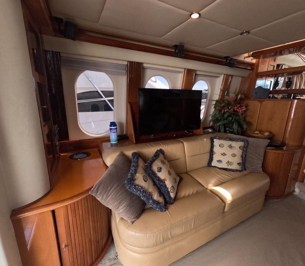 a living room with a couch and a tv aboard PYRAMID Yacht for Sale