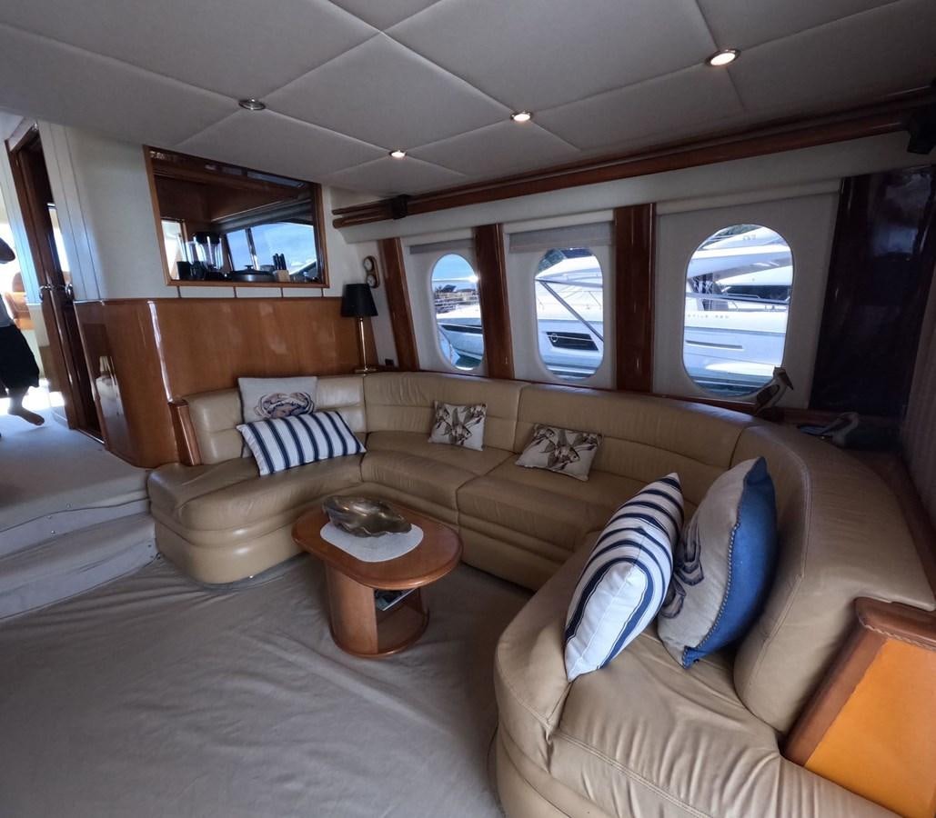 a living room with a couch and a coffee table aboard PYRAMID Yacht for Sale