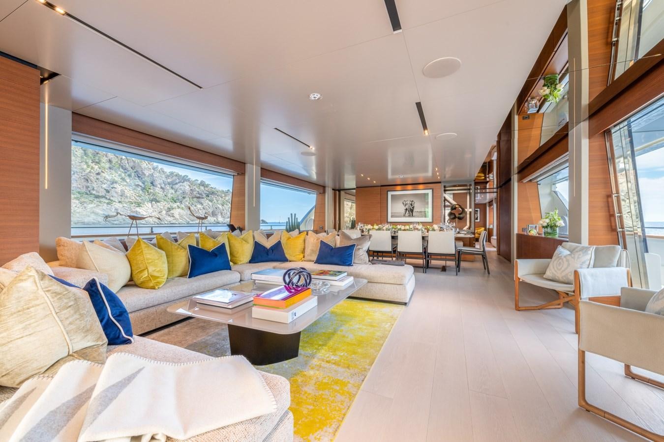 a living room with a couch and a table aboard MAC ONE Yacht for Sale