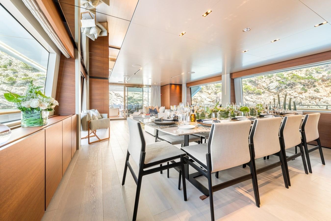a dining room with a table and chairs aboard MAC ONE Yacht for Sale