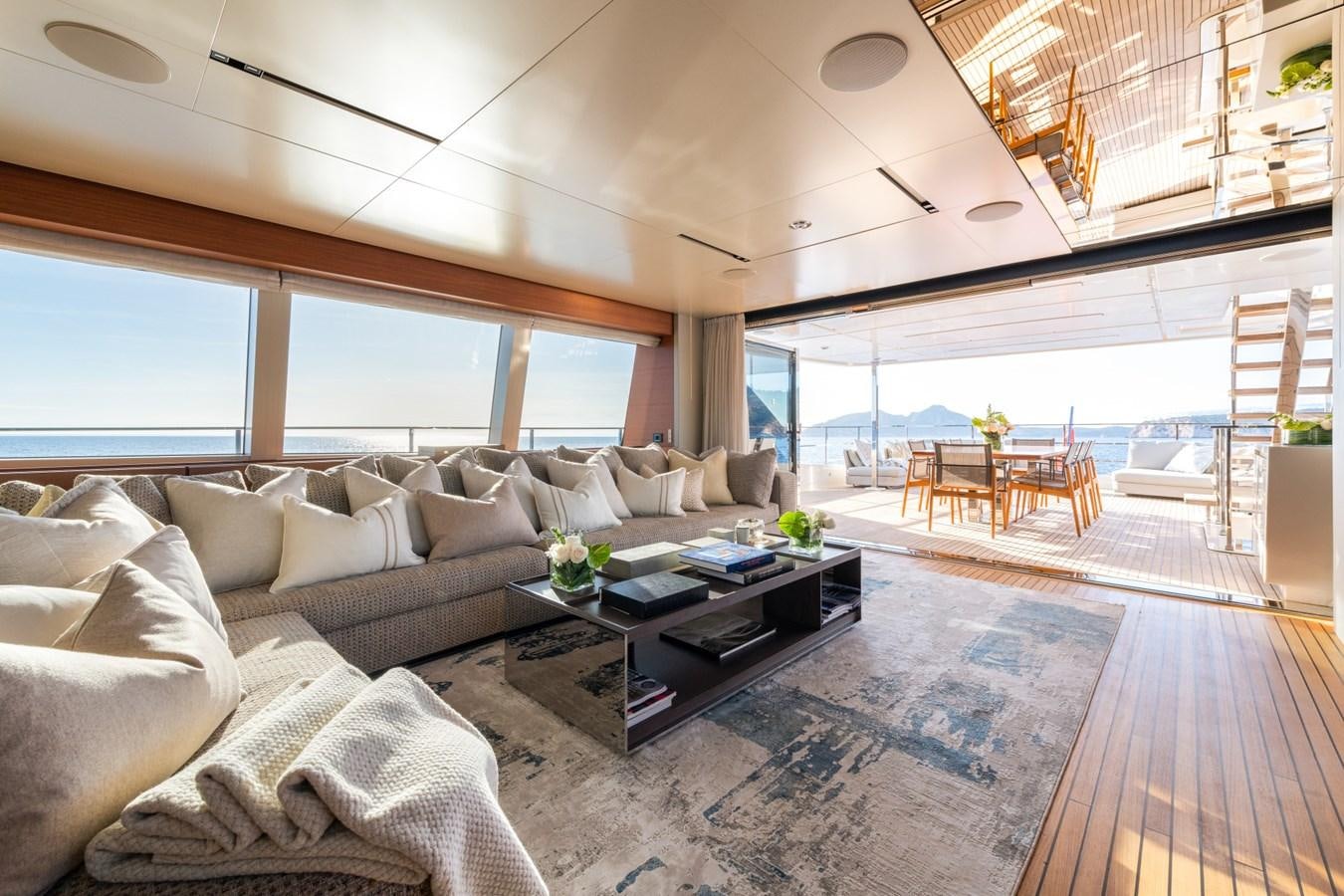 a living room with a large window aboard MAC ONE Yacht for Sale