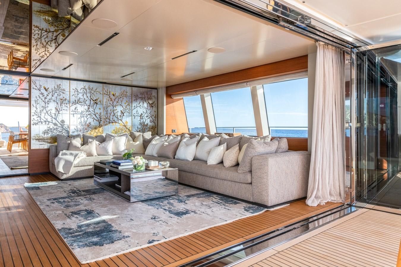 a living room with a large window aboard MAC ONE Yacht for Sale