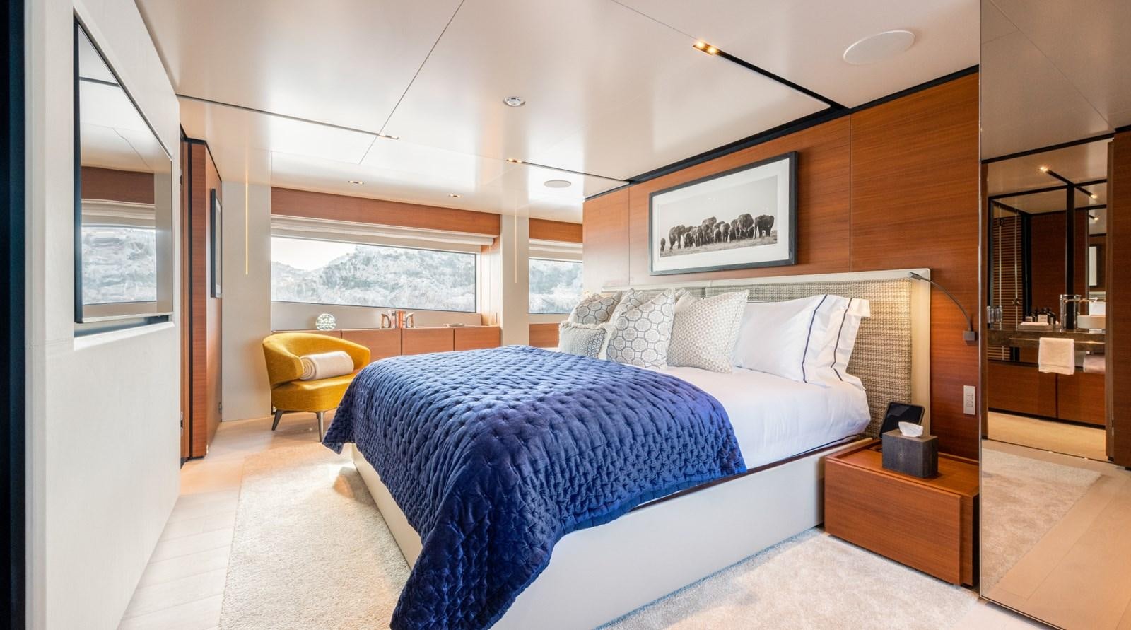 a bedroom with a bed and a desk aboard MAC ONE Yacht for Sale
