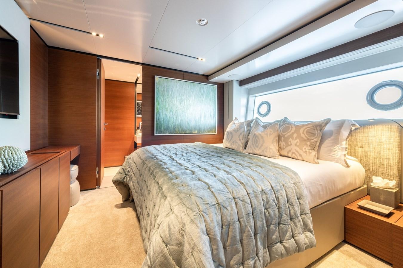 a bedroom with a bed and a wood door aboard MAC ONE Yacht for Sale