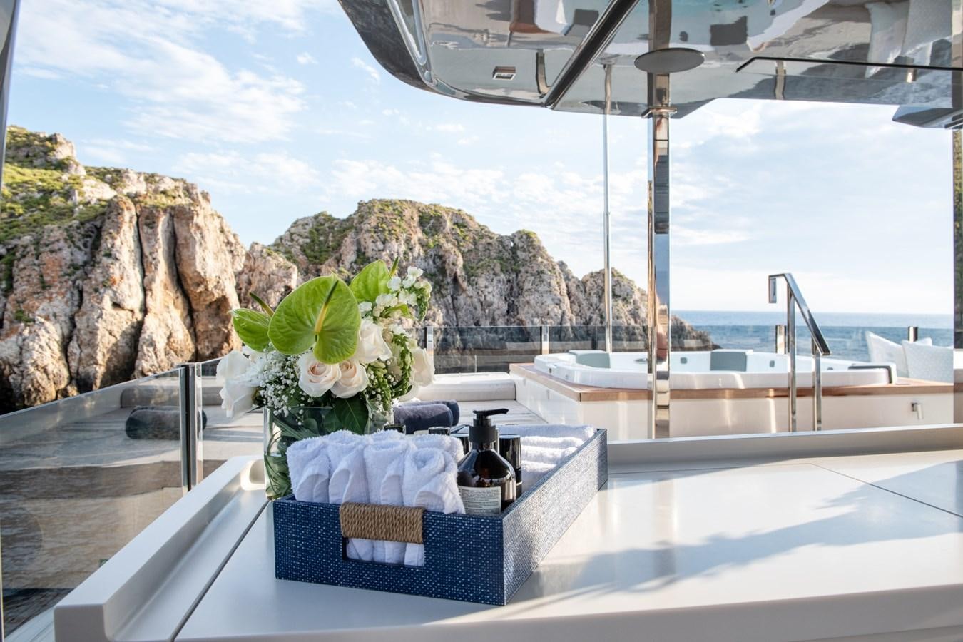 a table with a plant on it aboard MAC ONE Yacht for Sale
