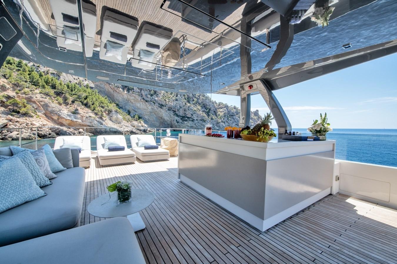 a patio with a table and chairs aboard MAC ONE Yacht for Sale