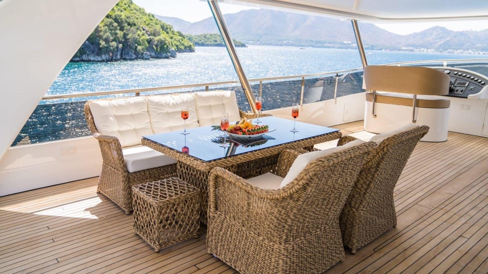 a table and chairs on a deck overlooking a body of water aboard 39,1 M CUSTOM BUILD MOTOR Yacht for Sale