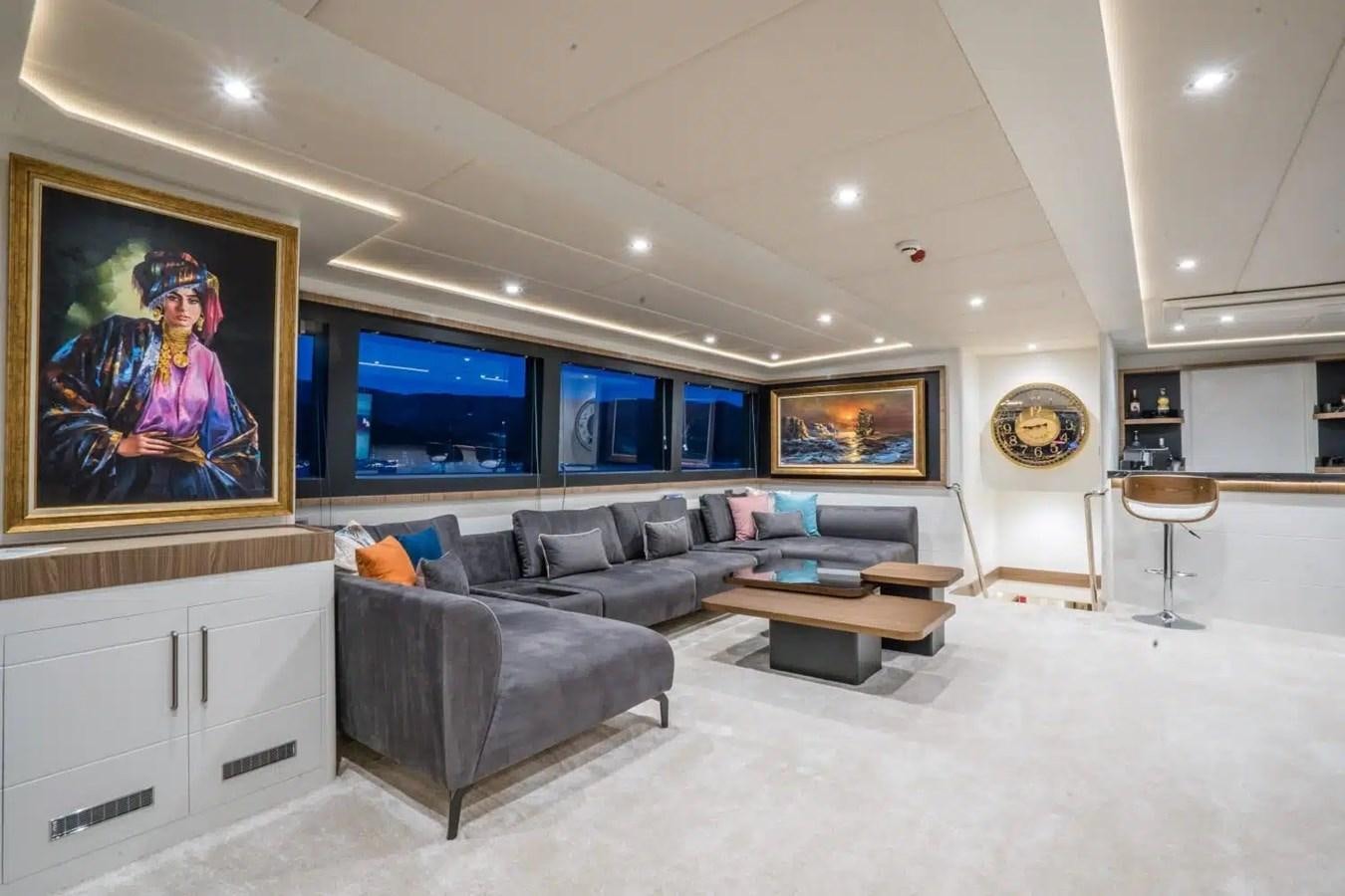 a living room with a large screen aboard 39,1 M CUSTOM BUILD MOTOR Yacht for Sale