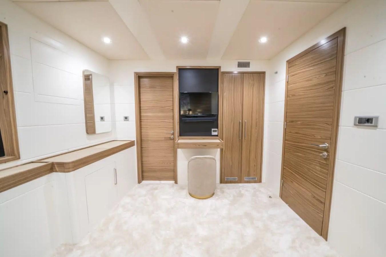 a room with a large white rug and wooden cabinets aboard 39,1 M CUSTOM BUILD MOTOR Yacht for Sale