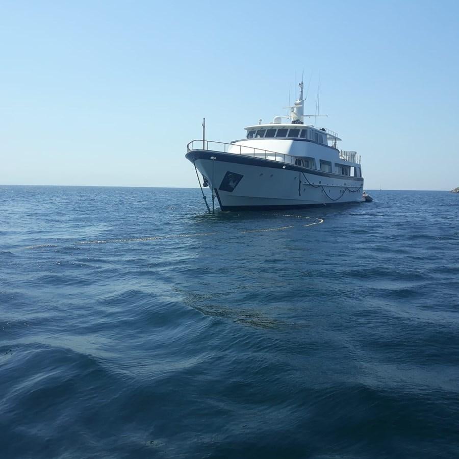 a white boat in the water aboard HAPPY Yacht for Sale