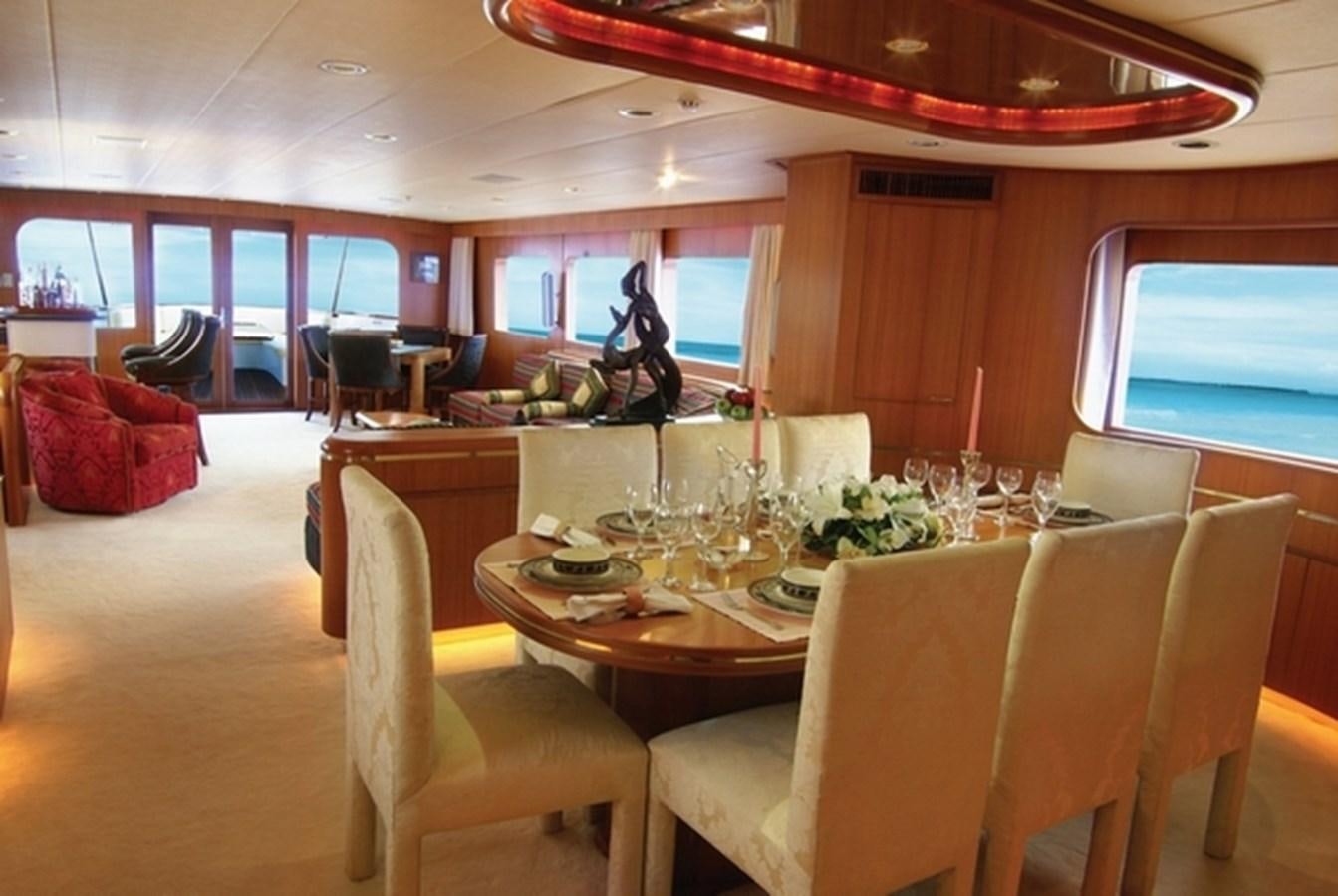a dining room with a statue aboard HAPPY Yacht for Sale