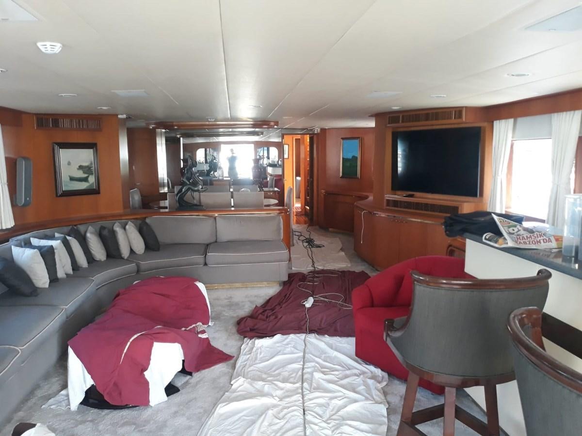 a living room with a couch and a television aboard HAPPY Yacht for Sale